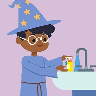 boy in wizard costume washing his hands