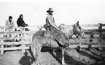 Cowboy on horse in corral