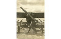 Man Turning Propeller of Aircraft, photograph, undated