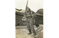 Pilot in Flight Suit with Cigarette by Open Cockpit US Mail Express Aircraft, photograph, undated