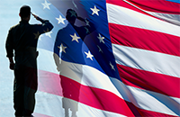 Soldier standing in front American Flag saluting