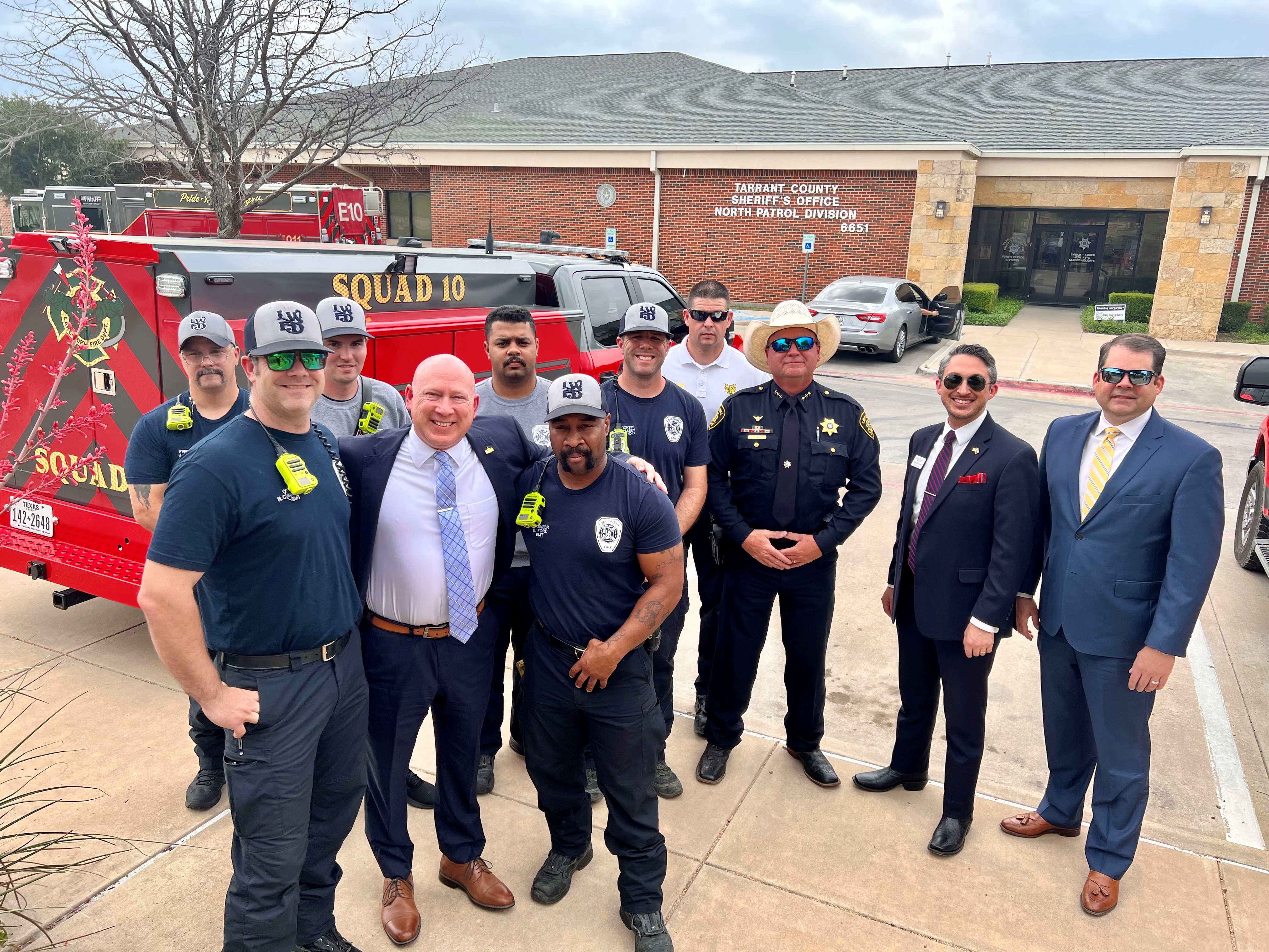Group photo of judge, firemen and others