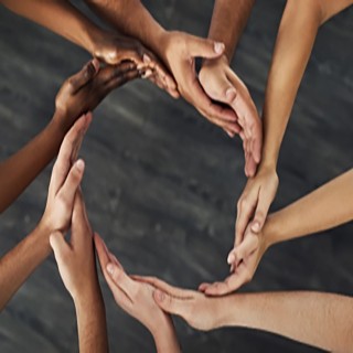 ethnic hands reaching out to form a circle together